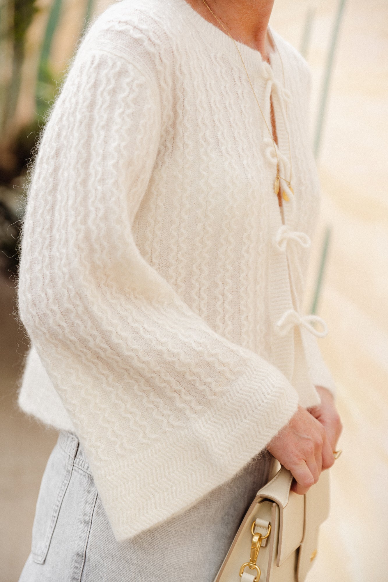Knitted cardigan with bow closing